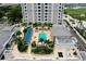 Aerial view showcasing the building, pool, surrounding amenities, and lush tropical landscaping at 331 Cleveland St # 320, Clearwater, FL 33755