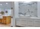 Modern bathroom featuring a vessel sink, white cabinets, and marble wall tiles at 331 Cleveland St # 320, Clearwater, FL 33755