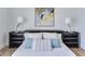 Comfortable bedroom featuring a unique art piece and reading lamps at 331 Cleveland St # 320, Clearwater, FL 33755