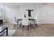Stylish dining area featuring a modern table, white chairs, and contemporary artwork at 331 Cleveland St # 320, Clearwater, FL 33755