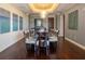 Formal dining room with a modern table and chairs under an ornate chandelier, set on hardwood floors at 331 Cleveland St # 320, Clearwater, FL 33755