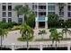 Elegant condo entrance with lush tropical landscaping and a stylish portico at 331 Cleveland St # 320, Clearwater, FL 33755