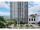 Modern high-rise condo with manicured landscaping and a circular driveway entrance at 331 Cleveland St # 320, Clearwater, FL 33755