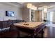 Elegant game room featuring a billiards table, entertainment center, and stylish furnishings at 331 Cleveland St # 320, Clearwater, FL 33755
