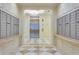 Hallway featuring an elevator and mailboxes with a sleek design, enhanced by marble flooring at 331 Cleveland St # 320, Clearwater, FL 33755