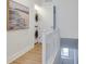 Hallway with a stacked washer/dryer set and a decorative painting at 331 Cleveland St # 320, Clearwater, FL 33755