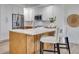 Contemporary kitchen with a central island, stainless steel appliances, and chic white cabinetry at 331 Cleveland St # 320, Clearwater, FL 33755