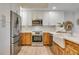 Modern kitchen with stainless steel appliances, a farmhouse sink, and stylish cabinetry at 331 Cleveland St # 320, Clearwater, FL 33755