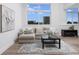 Bright living room with sectional sofa, black coffee table, and large windows at 331 Cleveland St # 320, Clearwater, FL 33755