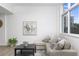 Cozy living room with a comfortable sectional sofa and an abstract painting at 331 Cleveland St # 320, Clearwater, FL 33755