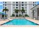 Resort-style community pool surrounded by lush landscaping and comfortable lounge furniture at 331 Cleveland St # 320, Clearwater, FL 33755
