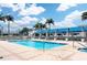 Spacious community pool with covered lounge areas, palm trees, and inviting clear water at 331 Cleveland St # 320, Clearwater, FL 33755