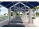 Relaxing poolside lounge area with blue sun shades and reclining chairs, perfect for unwinding under the sun at 331 Cleveland St # 320, Clearwater, FL 33755