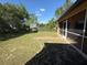 View of the backyard featuring the screened-in porch and a storage shed at 3355 Abeline Rd, Spring Hill, FL 34608
