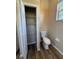 Bathroom featuring a toilet, closet, and a window at 3355 Abeline Rd, Spring Hill, FL 34608