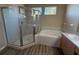 Bathroom featuring a glass-enclosed shower, tub, and a sink with wood cabinets at 3355 Abeline Rd, Spring Hill, FL 34608