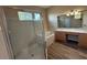 Bathroom features a glass-enclosed shower, bathtub, and dual sink vanity at 3355 Abeline Rd, Spring Hill, FL 34608