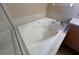 Bright bathroom featuring a clean, white square bathtub with chrome fixtures at 3355 Abeline Rd, Spring Hill, FL 34608