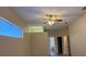 Bedroom boasting a ceiling fan, wood-look laminate flooring, and transom window at 3355 Abeline Rd, Spring Hill, FL 34608