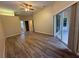 Spacious bedroom featuring a ceiling fan, wood-look floors, and sliding glass doors at 3355 Abeline Rd, Spring Hill, FL 34608