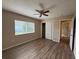 Bedroom with window, closet, ceiling fan and wood-look floors at 3355 Abeline Rd, Spring Hill, FL 34608