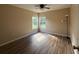 A sunlit bedroom featuring hard surface floors and a ceiling fan at 3355 Abeline Rd, Spring Hill, FL 34608