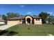 Charming single-story home featuring a well-manicured lawn and neutral color palette at 3355 Abeline Rd, Spring Hill, FL 34608