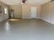 Spacious garage with painted floor, overhead lighting, and neutral paint at 3355 Abeline Rd, Spring Hill, FL 34608