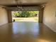 The garage has a painted floor and an automatic door opener at 3355 Abeline Rd, Spring Hill, FL 34608