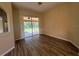Spacious living room features sliding glass doors to a lanai, enhanced by neutral paint and new floors at 3355 Abeline Rd, Spring Hill, FL 34608