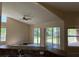 Living room view showcases vaulted ceiling, fan, and outdoor views at 3355 Abeline Rd, Spring Hill, FL 34608