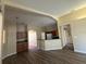 Open-concept living space with a kitchen bar featuring wood cabinets and a modern refrigerator at 3355 Abeline Rd, Spring Hill, FL 34608