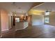 Bright and airy living room with a view of the kitchen, featuring new floors and modern lighting at 3355 Abeline Rd, Spring Hill, FL 34608