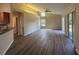 Open floor plan features wood floors, high ceilings, and natural light from backyard views at 3355 Abeline Rd, Spring Hill, FL 34608