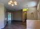 Open concept living room featuring sliding glass doors, neutral paint, and new floors, perfect for entertaining at 3355 Abeline Rd, Spring Hill, FL 34608