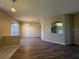Open-concept living and dining area with wood floors and neutral paint throughout at 3355 Abeline Rd, Spring Hill, FL 34608
