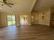 Open-concept living room with modern flooring and sliding glass doors to the outdoors at 3355 Abeline Rd, Spring Hill, FL 34608
