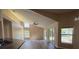 The living room has a vaulted ceiling, fan, and views of the backyard at 3355 Abeline Rd, Spring Hill, FL 34608