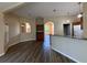 Open living space with wood-look floors and archways connecting to the kitchen at 3355 Abeline Rd, Spring Hill, FL 34608
