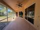 Covered patio with screened walls, a ceiling fan, and views of the yard at 3355 Abeline Rd, Spring Hill, FL 34608