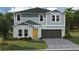 Charming two-story home with gray siding, a yellow front door, and an attached two-car garage at 37087 Sagemoor Dr, Zephyrhills, FL 33541