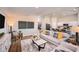 Bright living room with an open floor plan, hardwood floors, modern furnishings, and an adjacent kitchen at 37111 Sagemoor Dr, Zephyrhills, FL 33541