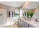 Bright bathroom featuring double sinks, grey cabinets, modern fixtures, and a walk-in shower at 37213 Sagemoor Dr, Zephyrhills, FL 33541