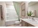 Clean bathroom featuring a shower-tub combination, modern vanity, and fresh decor at 37213 Sagemoor Dr, Zephyrhills, FL 33541