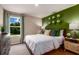 Bright bedroom features fun sports decor, green accent wall, and a window view at 37213 Sagemoor Dr, Zephyrhills, FL 33541