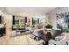 Open-concept living and dining area with contemporary decor and wood-look floors at 37213 Sagemoor Dr, Zephyrhills, FL 33541
