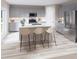 Modern kitchen with stainless steel appliances, grey cabinets, a kitchen island and three bar stools at 37213 Sagemoor Dr, Zephyrhills, FL 33541