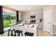 Open kitchen with stainless steel appliances, grey cabinets, a large island and a large window at 37213 Sagemoor Dr, Zephyrhills, FL 33541