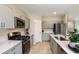 Modern kitchen featuring stainless steel appliances, light wood floors and white countertops at 37213 Sagemoor Dr, Zephyrhills, FL 33541