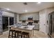 Modern kitchen features gray cabinets, an island with seating, and stainless steel appliances at 37213 Sagemoor Dr, Zephyrhills, FL 33541